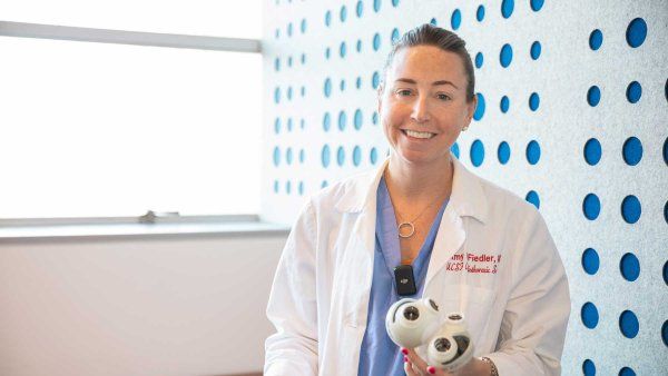 Heart surgeon Amy Fiedler holds a device with two pumps that works as an artificial heart.