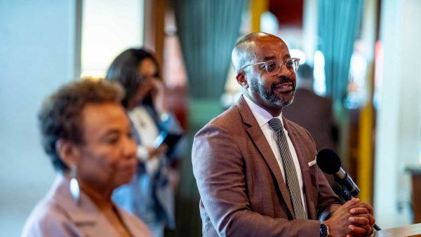 U C S F President Nicholas Holmes and Oakland mayor Barbara Lee stand together at at podium.