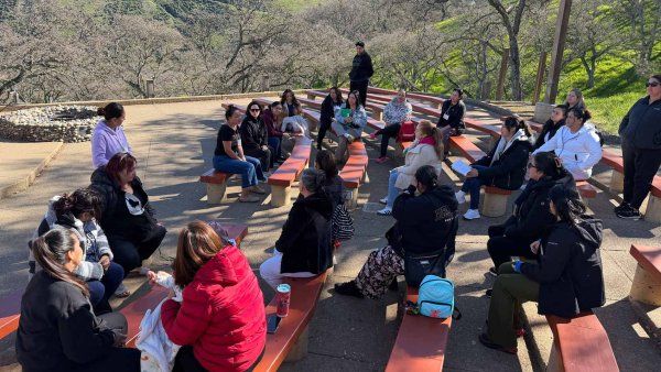 A group of people sit in an outdoor ampitheater in Northern California.