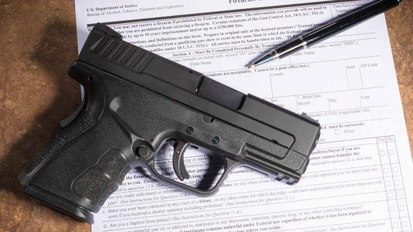 A gun and a firearm registration document.