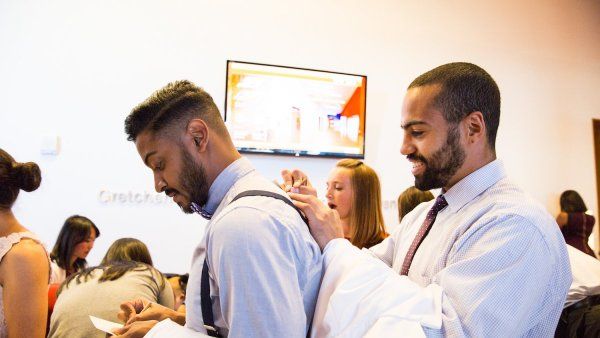 Students fill out name cards for the School of Medicine White Coat Ceremony