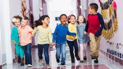 Children running together while holding hands