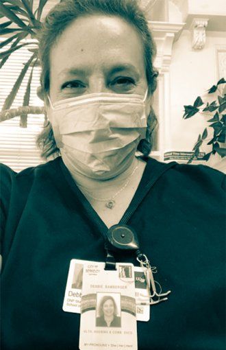 Portrait of Debbie Branberger in a surgical mask.