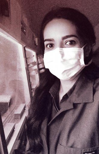 Portrait of Faranak Fattahi in the lab with a face mask on.
