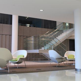 The interior of Mission Hall showing a large open lobby with minimalist chairs