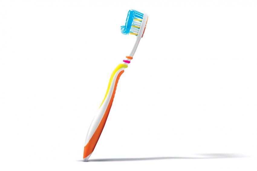 Photo of a toothbrush with blue toothpaste.