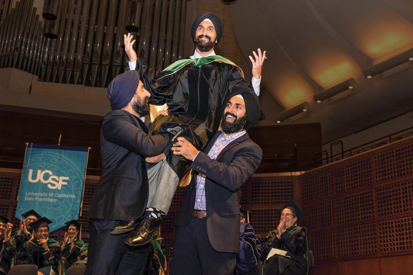 Paul and Ravi Gogia lift their younger brother Shawn onto their shoulders at his graduation ceremony.