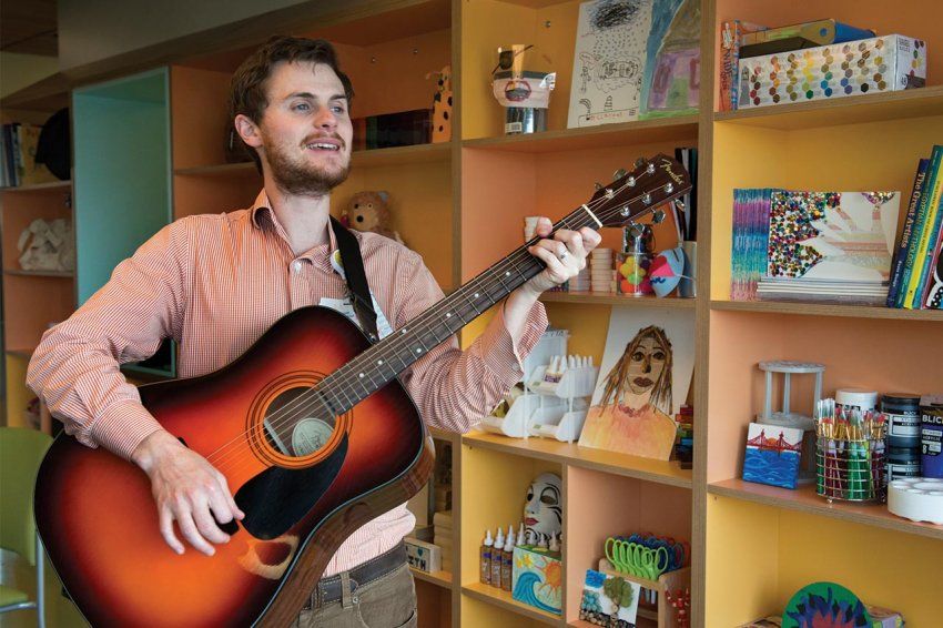 Oliver Jacobson plays a guitar at UCSF Benioff Children’s Hospital at Mission Bay.