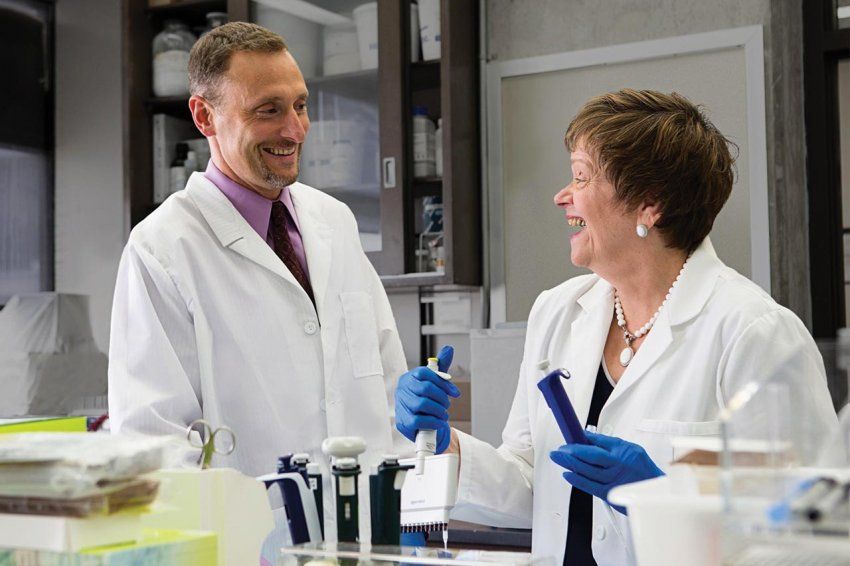 A scientists talking in a lab.