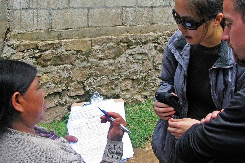 Nurses help a Guatemalan resident fill out a form.