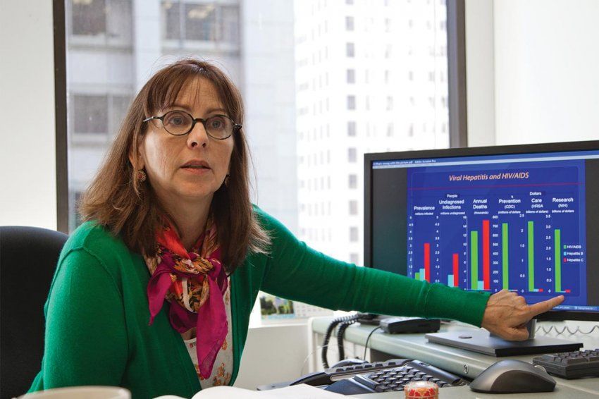 Kim Page points to a chart on a computer screen.