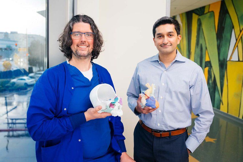 Michael Bunker and Shafkat Anwar stand with 3D printed anatomical models at UCSF’s Benioff Children’s Hospital San Francisco.